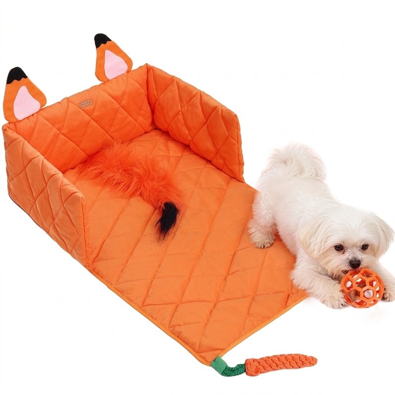 Small white dog playing on an orange fox dog play mat with interactive toys